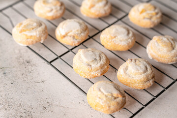 Italian cherry sugar cookies on a white plate. Powder sugar covered cookies.