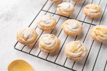 Italian cherry sugar cookies on a white plate. Powder sugar covered cookies.