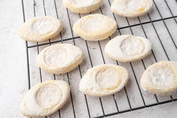 Italian lemon sugar cookies on a white plate. Powder sugar covered cookies.