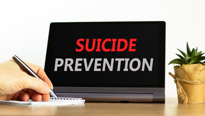 Suicide prevention symbol. Concept words Suicide prevention on beautiful tablet. Psychologist hand....