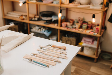 Set of craft sculpting tools on table in pottery workshop. Pottery gears for molding ceramics.