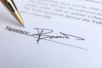 Ballpoint pen and signature on contract, closeup