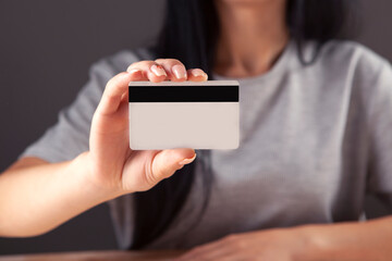 woman presenting credit card in hand