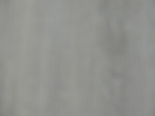 blurry brown-gray background with unclear surface pattern, muddy dark bokeh with defocused pattern, blur in gray tones as an empty backdrop