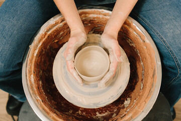 Potter creates a ceramic bowl in the pottery studio. Process of making a unique ceramic shape.