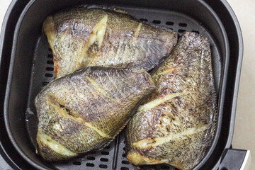 Close up gourami fish in air fryer, Heat treatment