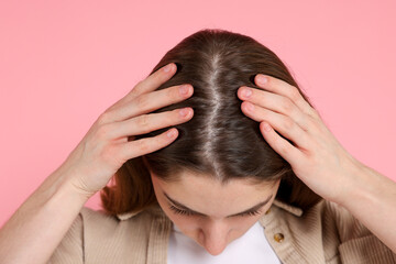 Girl with hair loss problem on pink background