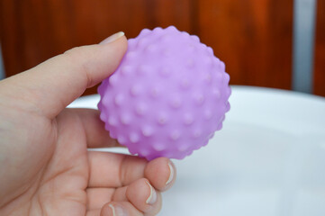 hand holding sensory textured ball babies toddlers tactile stimulation sensory play early childhood...