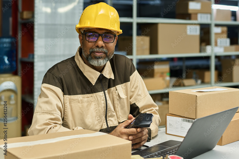 Aufkleber happy multiethnic warehouse worker in hardhat and workwear looking at camera while scanning barcodes