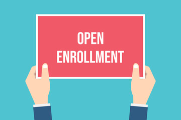The human hand holds a open enrollment sign