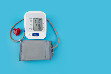 Red toy heart and tonometer on blue background. Healthcare concept. Cardiology - Heart care