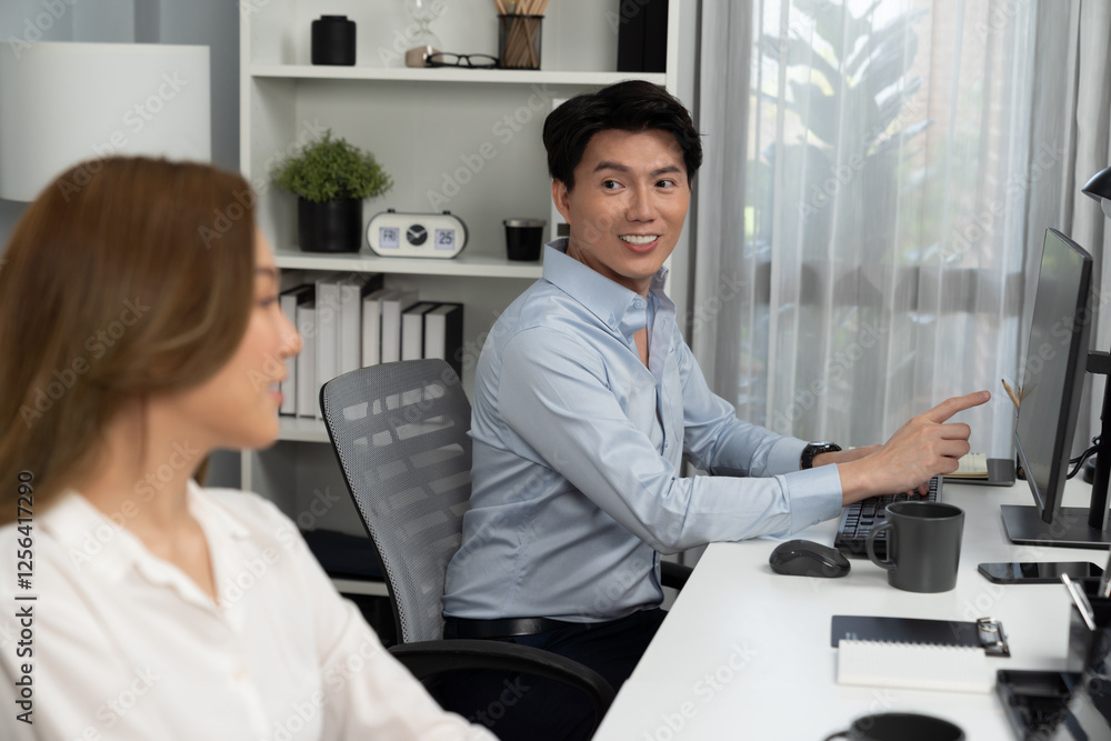 Poster smiling asian man talking with woman colleague in planning marketing report project on laptop casual