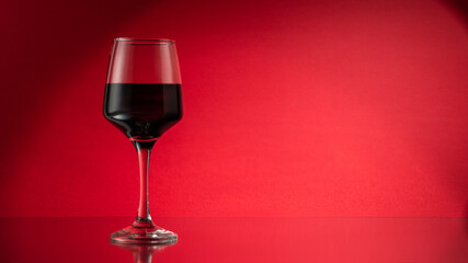 Red wine glass on table. Copy space for your text.
