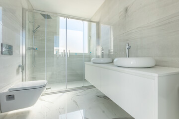 an image of a bathroom with large standing shower and double wash basins in luxury holiday home 