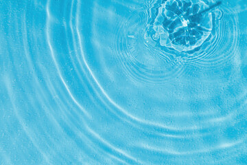 drops on water with circles on a blue background