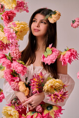 Beautiful young woman in red dress with peony flower background