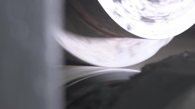 Leveling mechanism creates surface structure of product during rotation. Large rolls remove unevenness on long web for further material processing