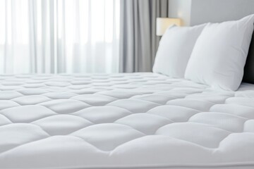 Bed with two white pillows and a white mattress