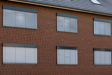 Bricks and blinds create a simple architectural design in a home