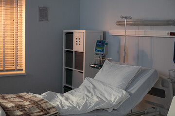 A contemporary hospital room equipped with an adjustable bed and generous natural light streams in