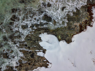 Artic seascape. Drone aerial top view of Winter landscape in Lofoten Islands, Norway. Color horizontal photography with amazing abstract effect. Snow and ice in wild nature.
