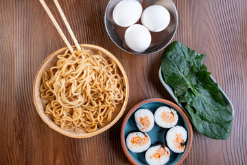 Close-up of dim sum setup sushi,noodles and egg