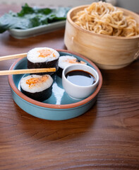 Close-up of dim sum setup sushi,noodles and egg