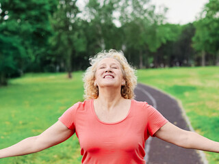 woman mature fitness dreaming relaxation exercise wellbeing meditating freedom inhaling carefree...