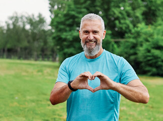 mature fitness man heart active love sport exercise healthy fit health middle aged shape male...