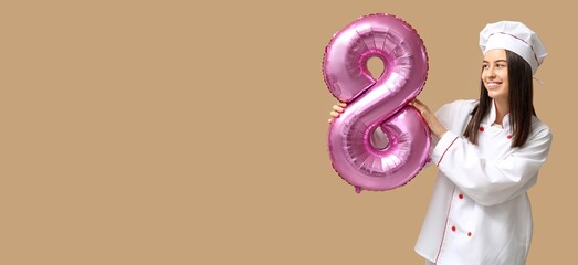 Female chef holding balloon in shape of figure 8 on beige background with space for text. International Women's Day celebration