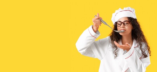 Female African-American chef with ladle on yellow background with space for text