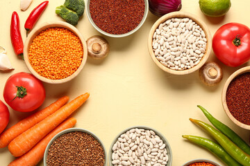 Frame made of different fresh vegetables and cereals on yellow background