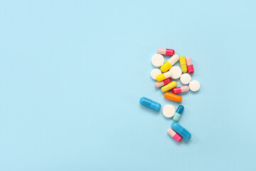 Different pills on blue background