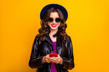 Portrait of charming cheerful positive girl use her cellphone comment text blog post wear black...