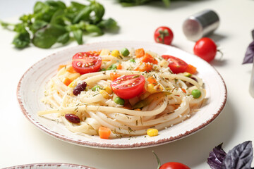 Plate with tasty pasta primavera on white background