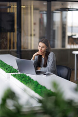 Business woman talking on a video call in a coworking office.