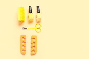 Set of professional tools for pedicure with nail polishes on yellow background