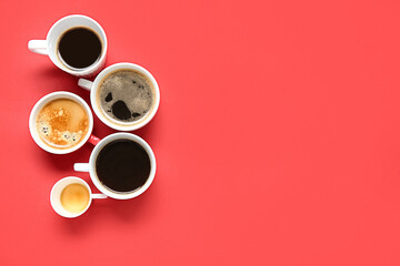Many cups of hot coffee on red background