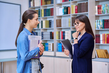 Meeting dialogue, teenage girl student talking with female teacher