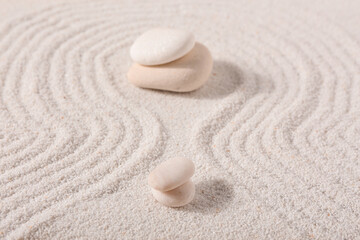 Stones on sand with lines in Japanese rock garden.  Zen concept