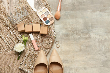 Wooden cubes with prom dress, shoes and accessories on grey grunge background