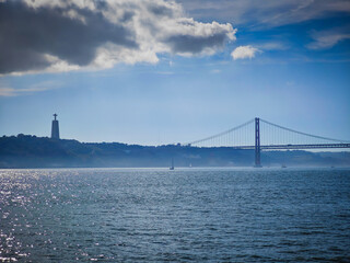 Obraz premium 25 April Bridge and Cristo Rei Statue, Tagus river. Panoramic view. Ponte 25 de Abril landmark of Lisbon