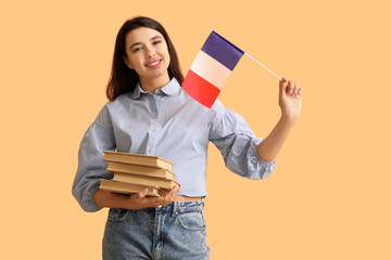 Female French language teacher with books and flag on yellow background