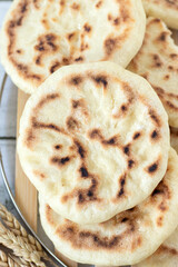 Homemade pita bread made with white wheat flour. Top view.