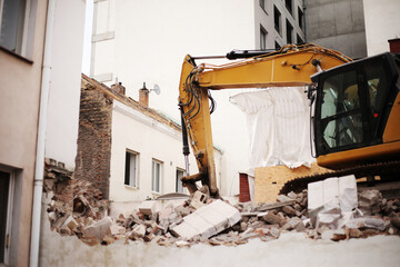 bulldozer excavator shoveling debris into pile with his ladle © Olga