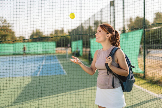 A female tennis player with a racket poised for a powerful swing