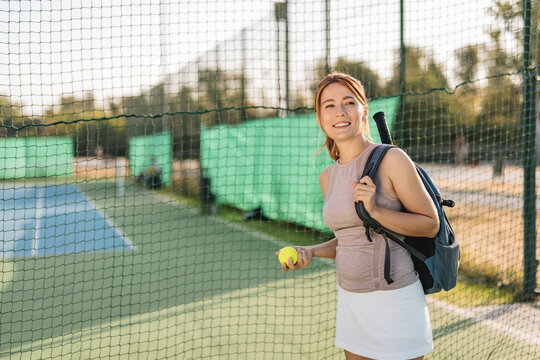 A female tennis player with a racket poised for a powerful swing