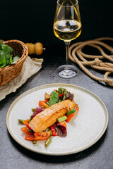 Grilled salmon fillet with fresh vegetables, served on a plate, elegant food presentation