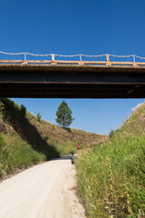 Man under bridge with e-bike on the George S. Mickelson Trail, South Dakota