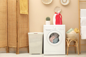 Wicker laundry basket, washing machine and detergents in bathroom